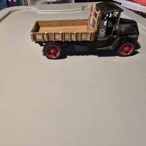 Vintage Black and Tan Toy Truck with Red Wheels